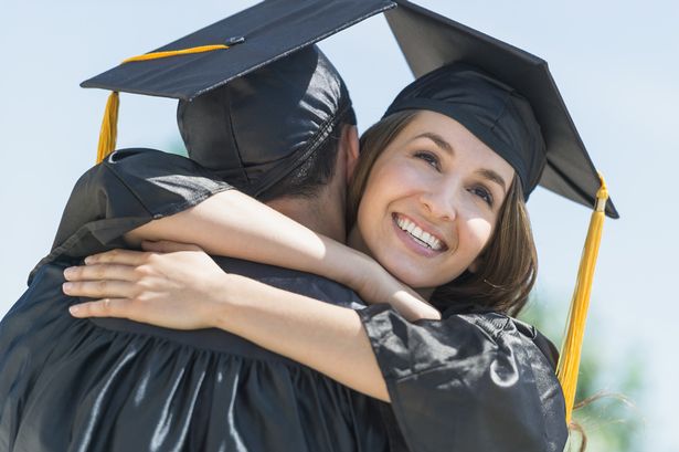 female-and-male-students-embracing-on-graduation-ceremony